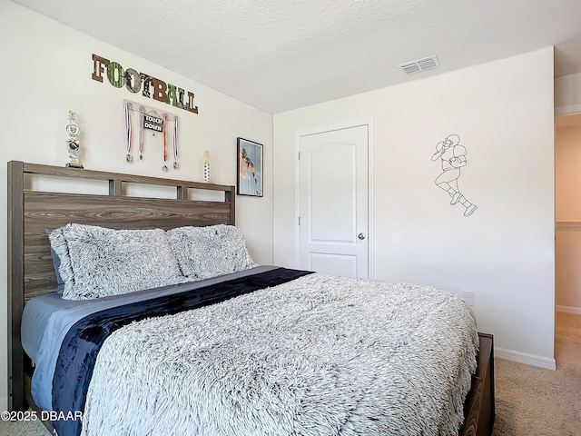 carpeted bedroom featuring a textured ceiling