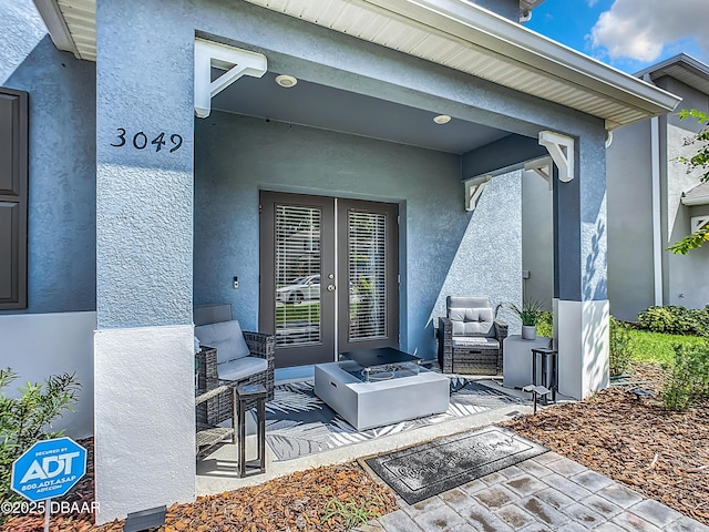 view of exterior entry featuring an outdoor living space