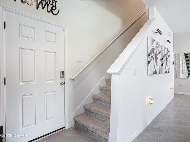 stairway with tile patterned floors