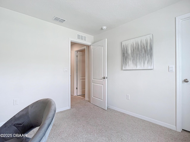 unfurnished office with light carpet and a textured ceiling