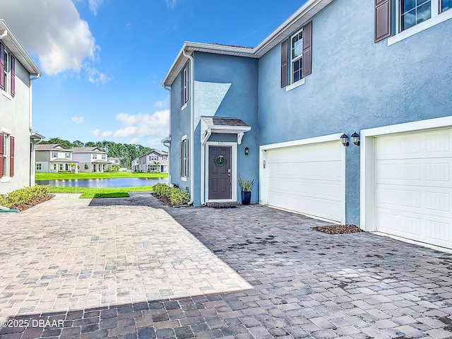 view of front of house featuring a water view and a garage