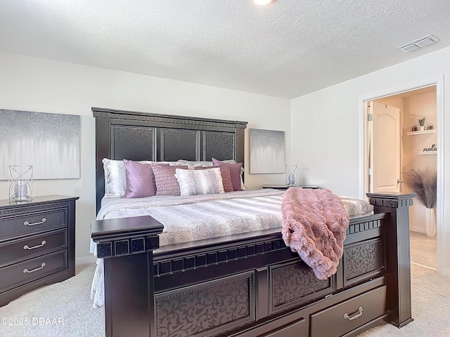 carpeted bedroom with a textured ceiling