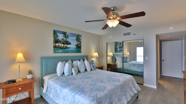 bedroom with hardwood / wood-style flooring, ceiling fan, and a closet