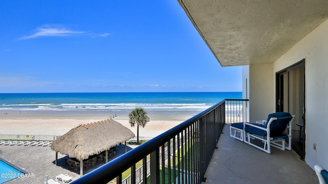 balcony with a beach view and a water view