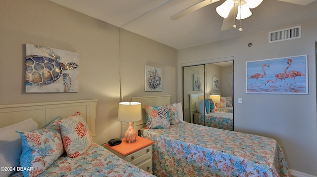 bedroom with ceiling fan and a closet