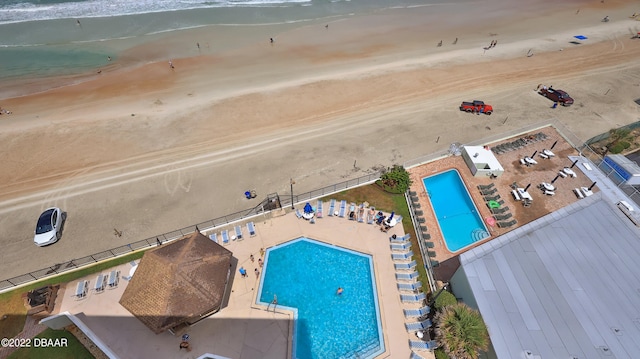 bird's eye view with a water view and a beach view