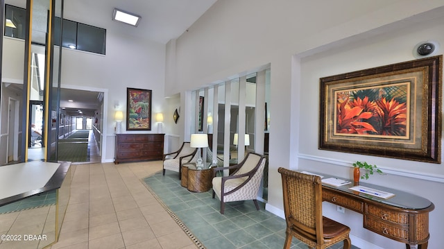 interior space featuring tile patterned flooring and a high ceiling