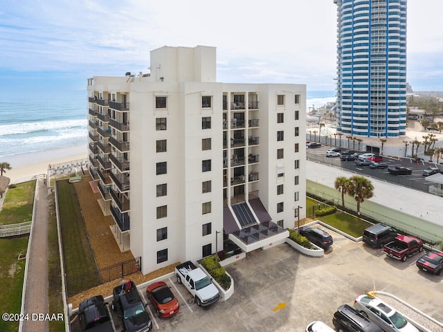 view of building exterior featuring a view of the beach and a water view