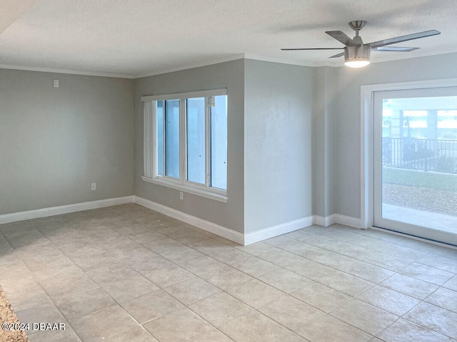 spare room featuring a textured ceiling, crown molding, and ceiling fan