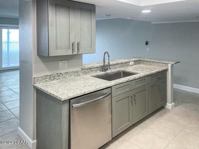 kitchen with dishwasher, sink, light stone counters, and light tile patterned floors