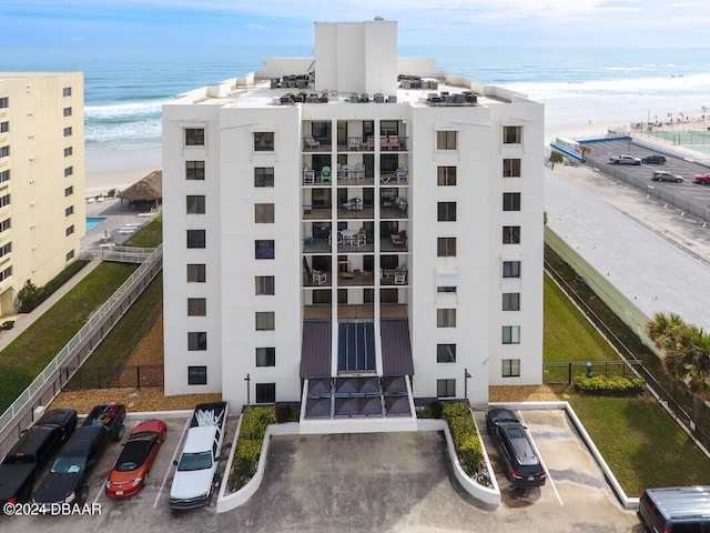 view of property featuring a water view and a view of the beach