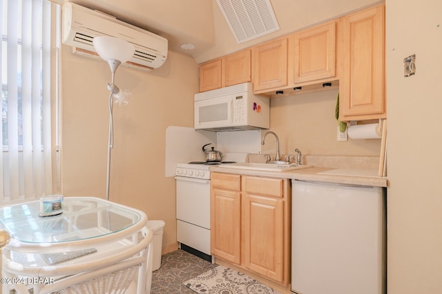 kitchen with light brown cabinets, white appliances, sink, and a wall mounted AC