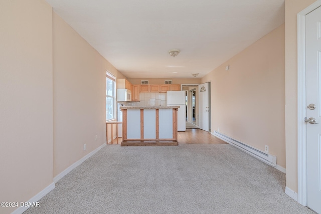 unfurnished living room featuring a baseboard radiator and light colored carpet