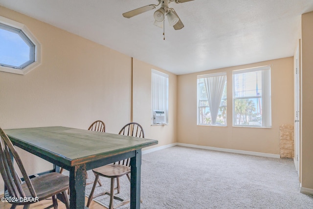 dining room featuring light carpet and ceiling fan