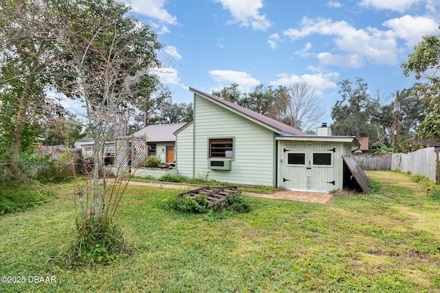 rear view of house featuring a yard