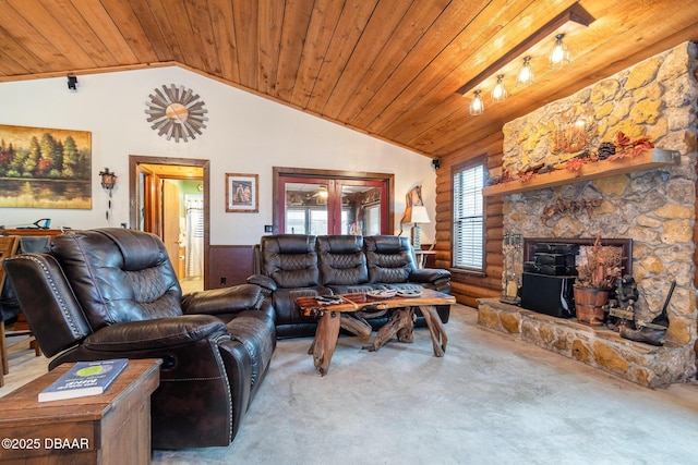 carpeted living room featuring a fireplace, wooden ceiling, and vaulted ceiling