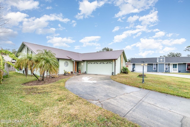 single story home featuring a front lawn and a garage