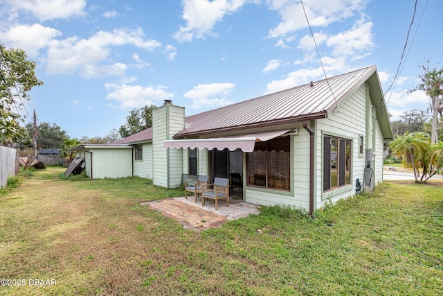 rear view of property with a patio area and a yard