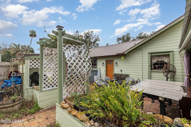 property entrance featuring a pergola