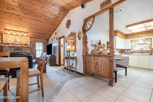 dining room featuring a wealth of natural light, light tile patterned floors, lofted ceiling, and wood ceiling