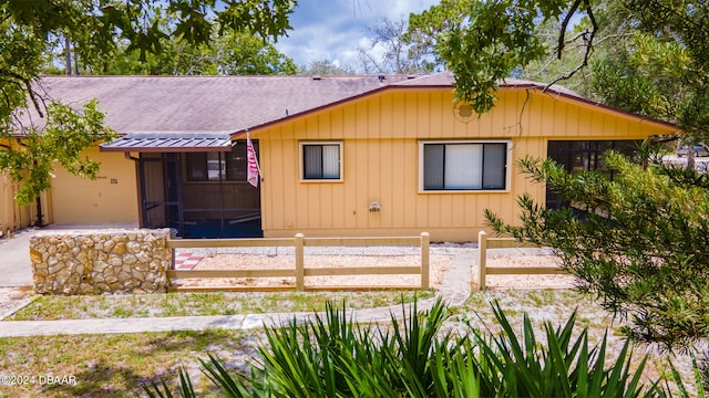 view of front of house with a sunroom