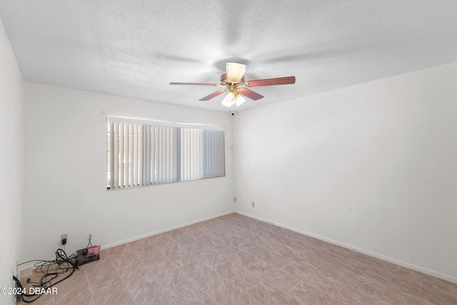 unfurnished room featuring a textured ceiling and ceiling fan