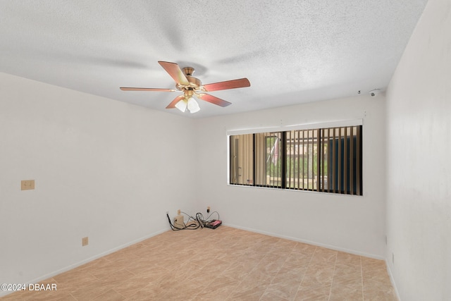 unfurnished room featuring a textured ceiling and ceiling fan