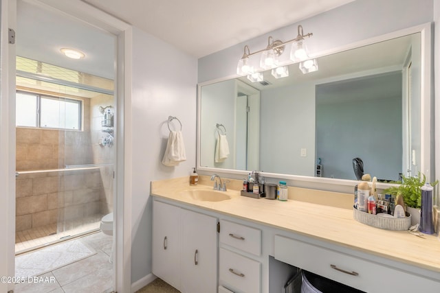 full bath featuring tile patterned floors, toilet, a stall shower, and vanity
