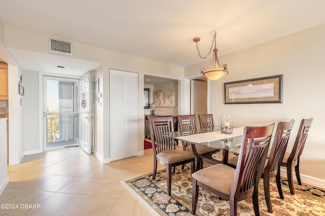 dining room featuring light tile patterned floors, baseboards, and visible vents