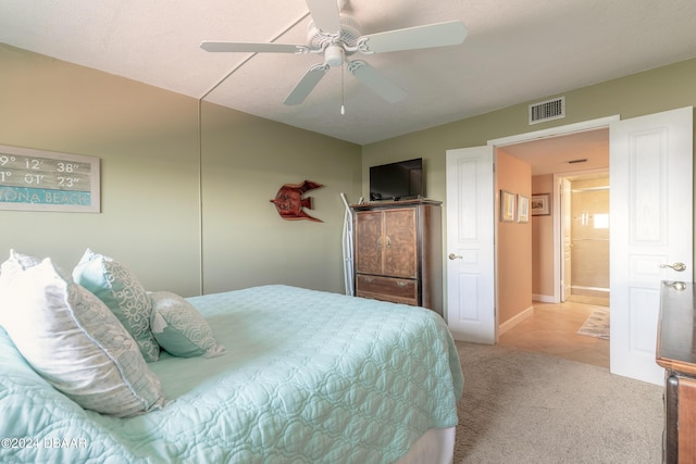 carpeted bedroom with visible vents, a ceiling fan, baseboards, and tile patterned flooring