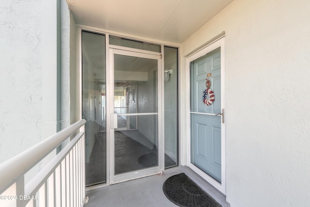 view of exterior entry with stucco siding