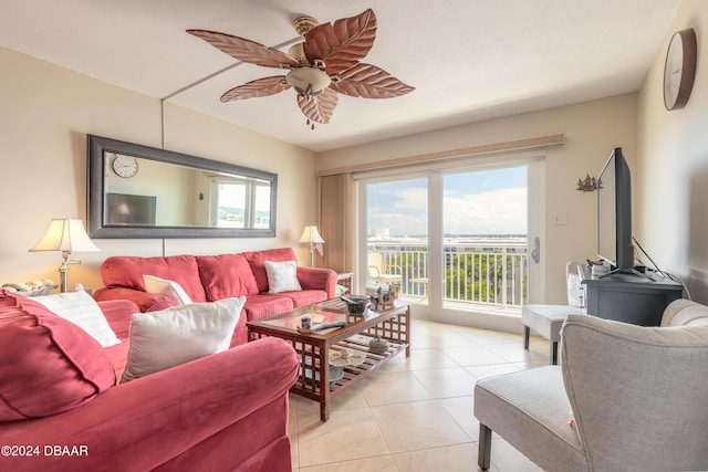 living area with a ceiling fan and light tile patterned flooring