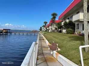 dock area with a water view and a yard