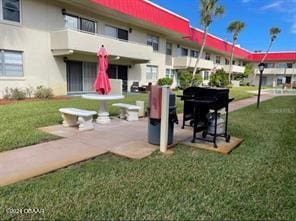 view of community featuring a yard and a patio area