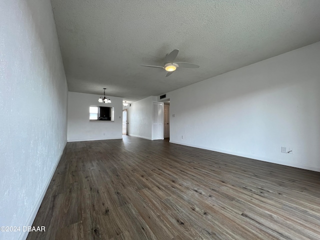 unfurnished living room featuring dark hardwood / wood-style flooring, a textured ceiling, and ceiling fan with notable chandelier