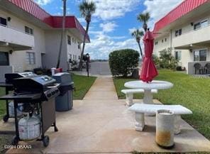 view of property's community featuring a patio area and a yard