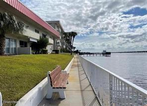 exterior space with a water view and a lawn