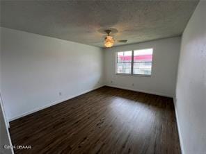 empty room featuring ceiling fan and dark hardwood / wood-style floors