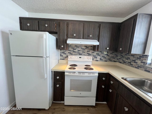 kitchen with white appliances, decorative backsplash, dark brown cabinetry, and dark hardwood / wood-style floors