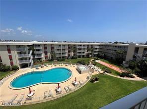 view of swimming pool with a lawn