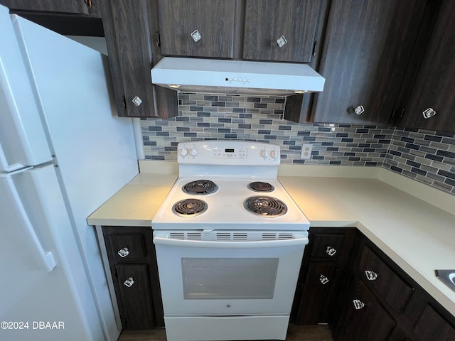 kitchen with dark brown cabinetry, white appliances, and backsplash