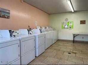 clothes washing area with washing machine and clothes dryer