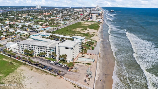 drone / aerial view featuring a water view and a view of the beach