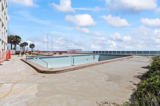 view of pool with a water view