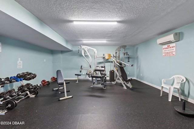 exercise area with an AC wall unit and a textured ceiling