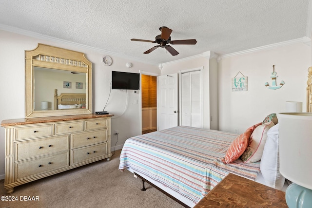 carpeted bedroom featuring ceiling fan, a closet, a textured ceiling, and ornamental molding