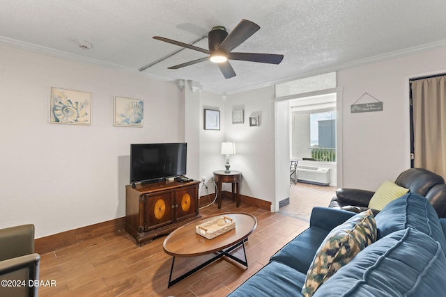 living room with ceiling fan, ornamental molding, and a textured ceiling