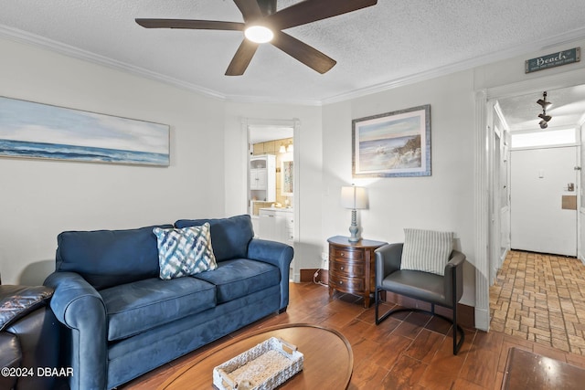 living room featuring ceiling fan, crown molding, and a textured ceiling