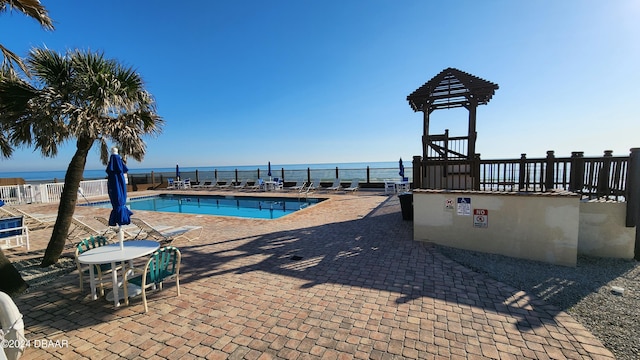 1233 N Atlantic Ave Unit 212, Daytona Beach, FL 32118 - community pool featuring fence, a patio, and a water view