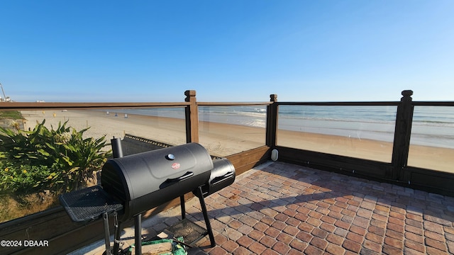 1233 N Atlantic Ave Unit 212, Daytona Beach, FL 32118 - view of patio featuring view of water and beach and a grill